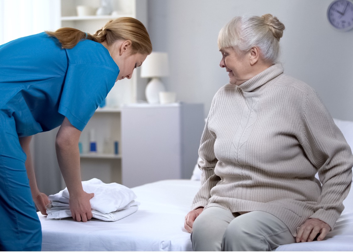 Caregiver assisting with light housekeeping